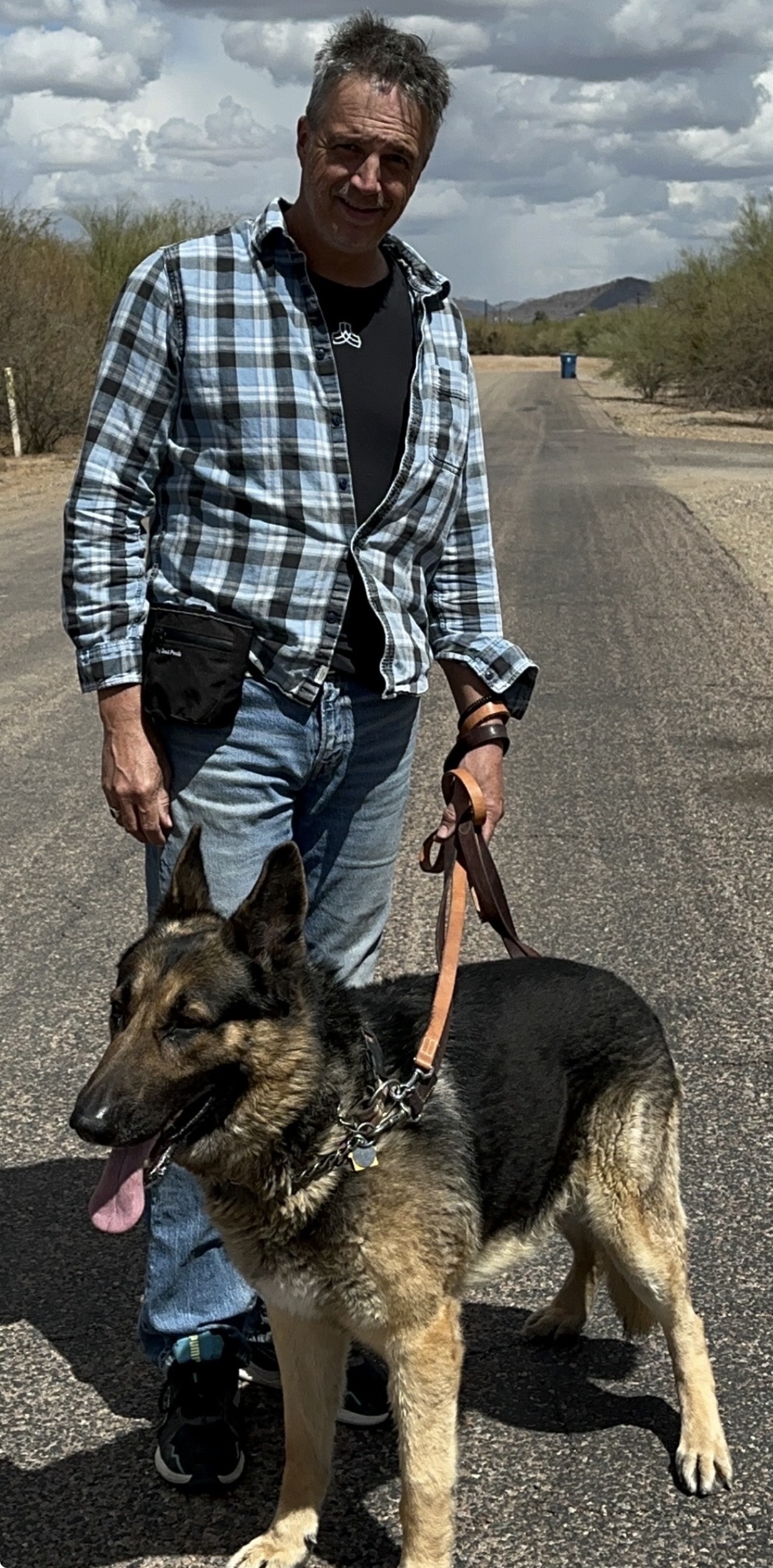 David standing with a German Shepherd